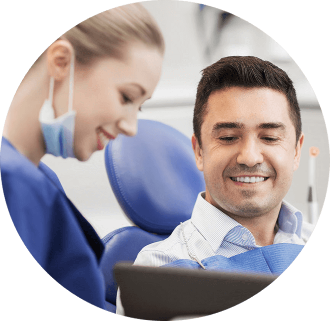 Dentist assistant helping patient go over anesthesia options.